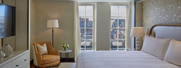 A view of the terrace from the bedroom of The Mayfair Pavilion, at Claridge's, with an Emperor bed, in an elegant design.