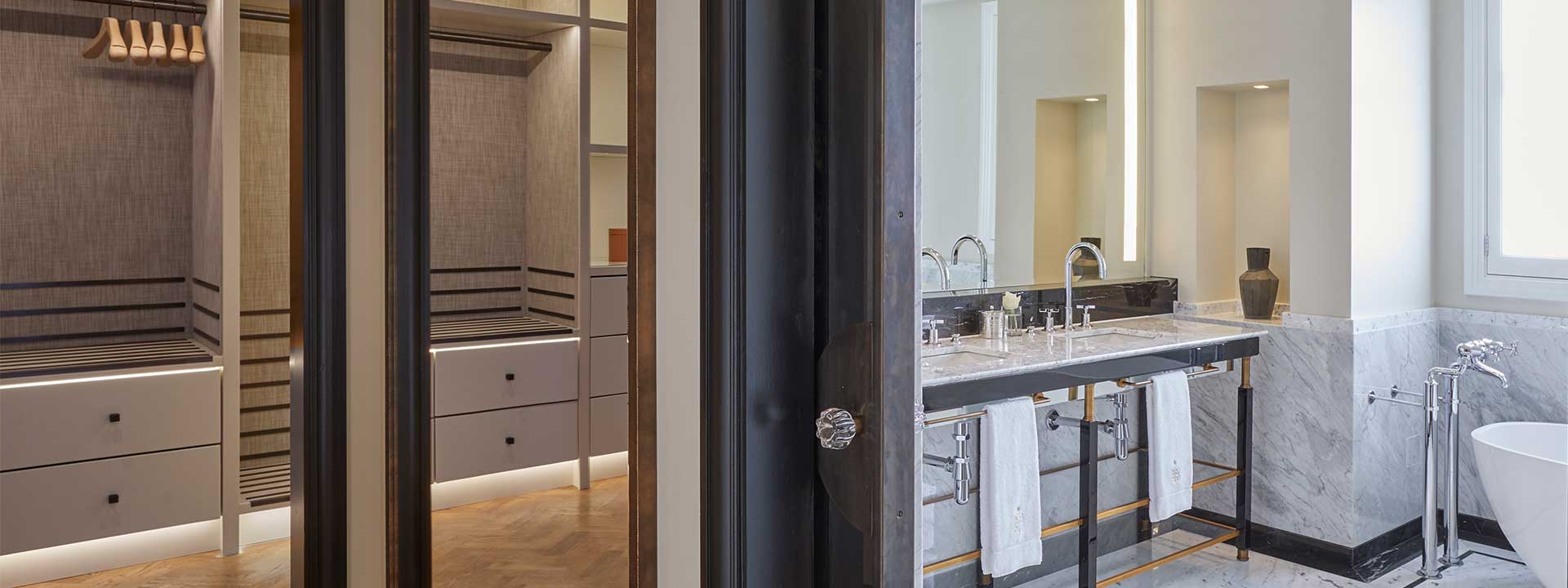 View of the large walk-in closet as well as the marble bathroom, in the Corner Terrace Suite.