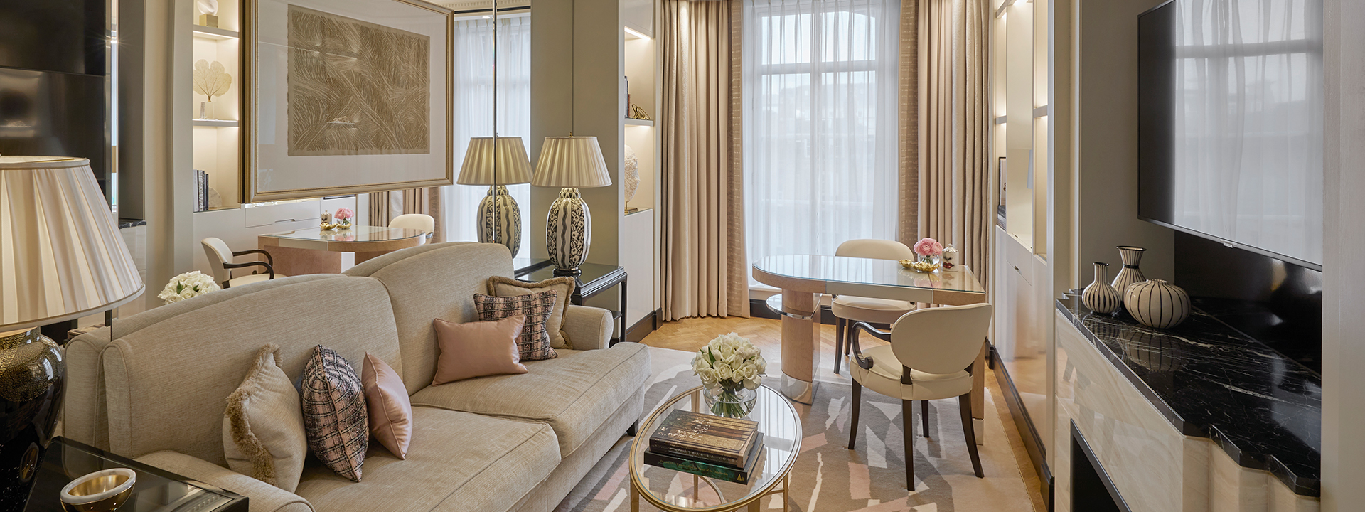 Spacious sitting area in the Deluxe Junior Suite, in neutral tones and luxurious details of the rich interior.