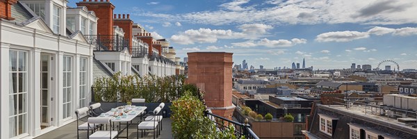 Grand Terrace Suite at Claridge's - terrace with large table and chairs and view on the roofs of London.