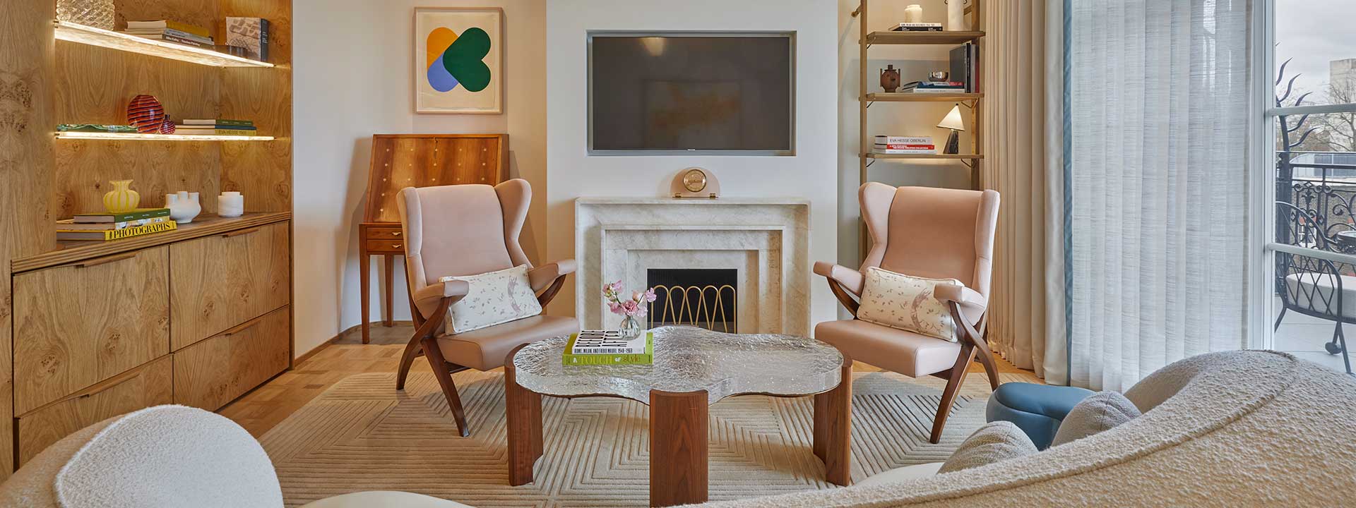 Part of the Mayfair Terrace Suite and its contemporary design with pink armchairs, and the rest of the comfortable interior.