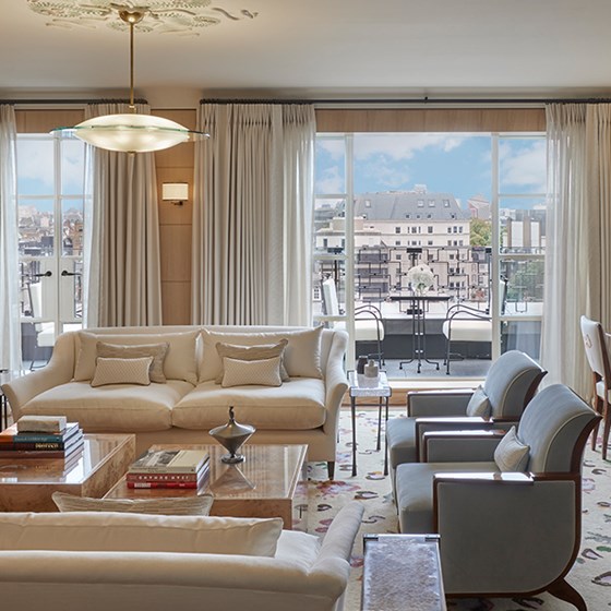 A view of the living room, elegant armchairs and sofas in an art deco interior from The Mews Pavilion at Claridge's.