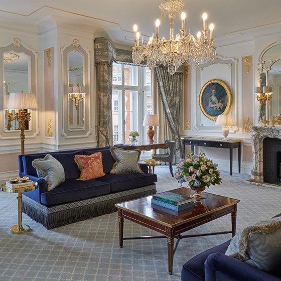 Blue sofas, and opulent crystal chandeliers, are in the luxurious interior of the Prince Alexander Suite at Claridge's Hotel.