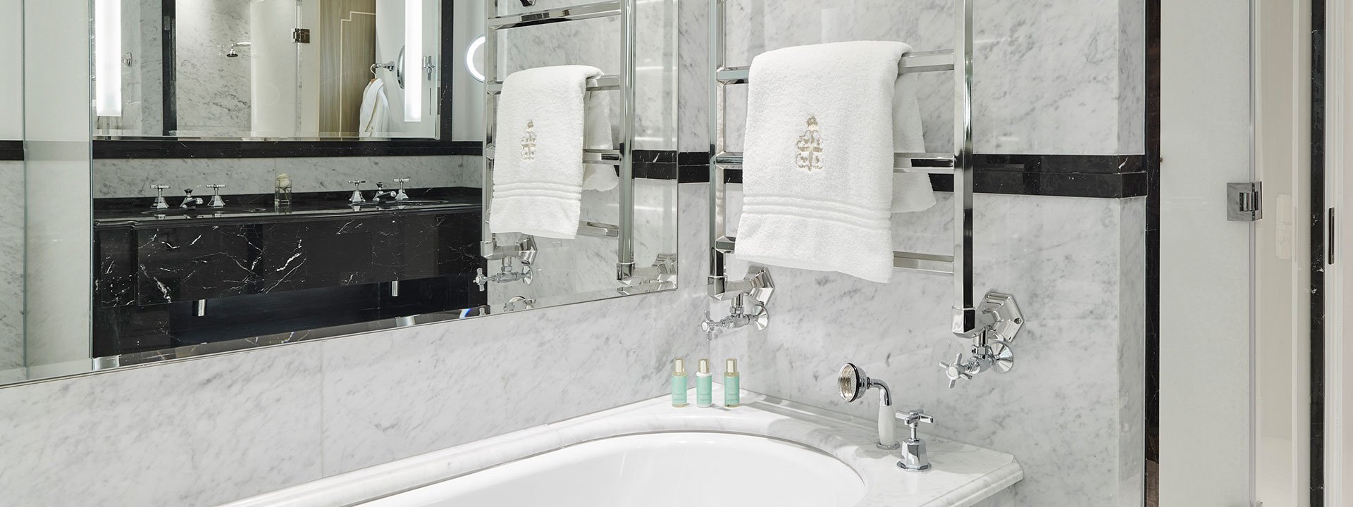 View of the contemporary-designed marble bathroom with heated mirrors in the Superior Room.