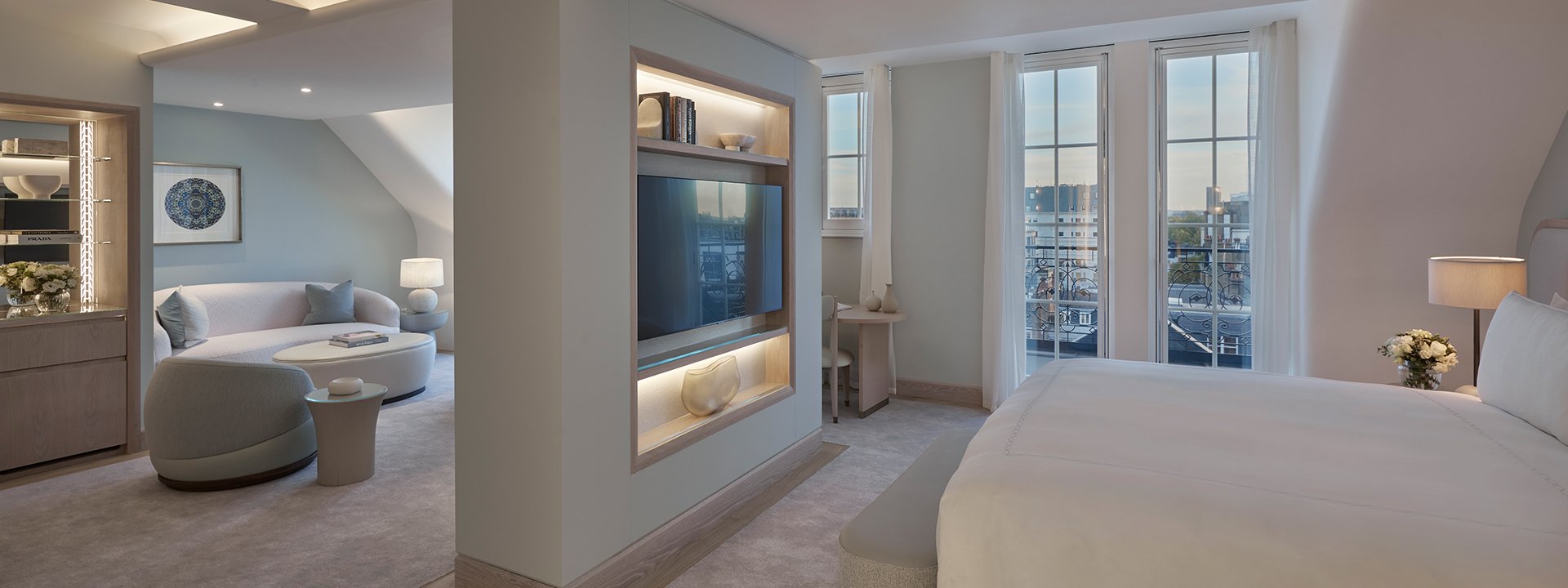The transition between the bedroom and sitting areas, in shades of grey and beige in the Terrace Junior Suite.