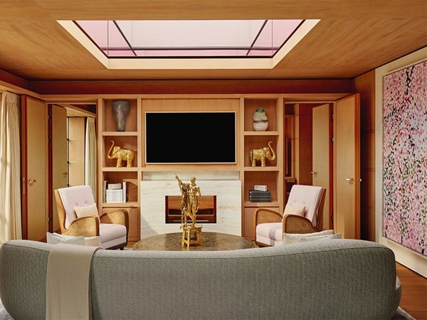 A stylish living room with wood paneling and a skylight ceiling