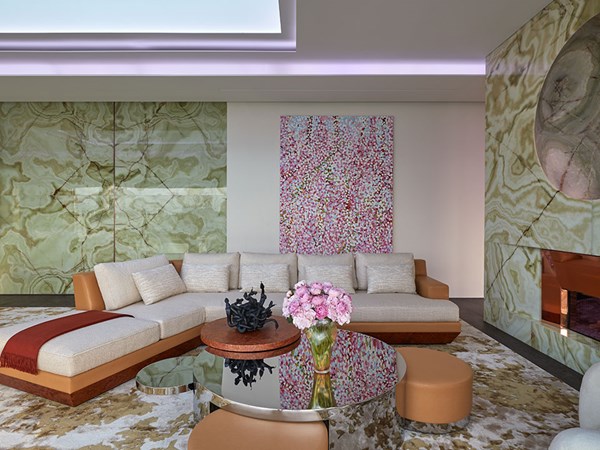 living area of the penthouse with white sofa and table with pink flowers