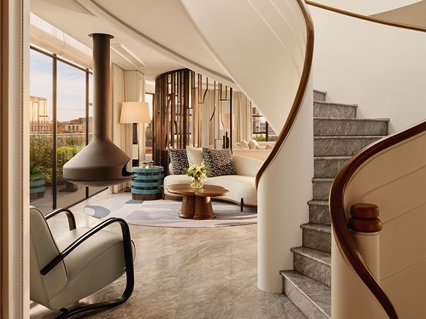 Elegant interior with a sculptural staircase and modern lounge.