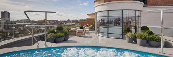 Bubbling hydrotherapy pool on terrace with London skyline backdrop
