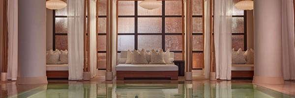 Claridge's spa pool and cream bed with cushions