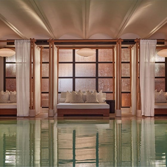 Claridge's Swimming pool and cream bed with cushions