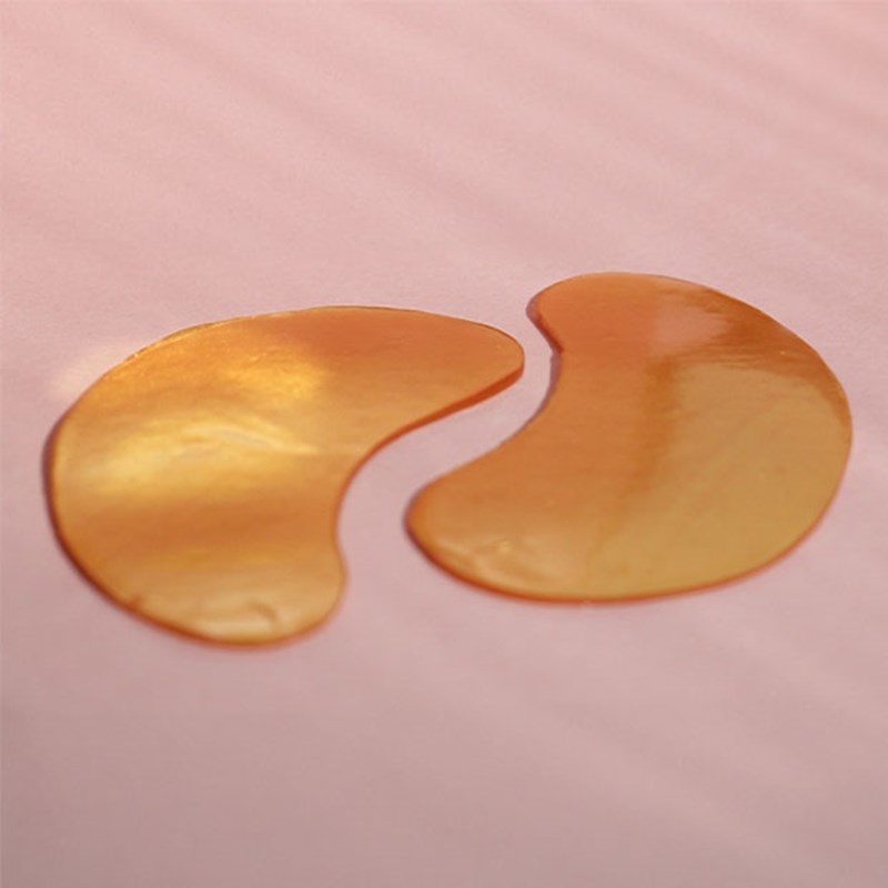 Gold MZ skin eye mask on pink background.