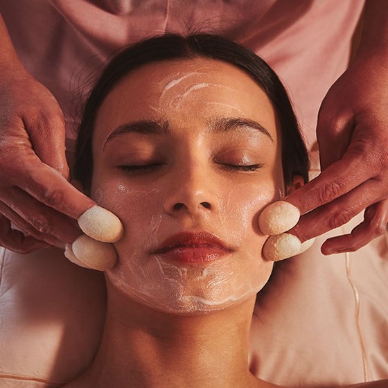 A view of a woman having a facial spa treatment, in the soothing atmosphere of Claridge's Spa.