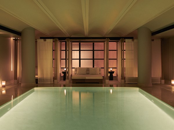 The pool at Claridge's Spa - swimming pool with open cabanas in the background and bed.