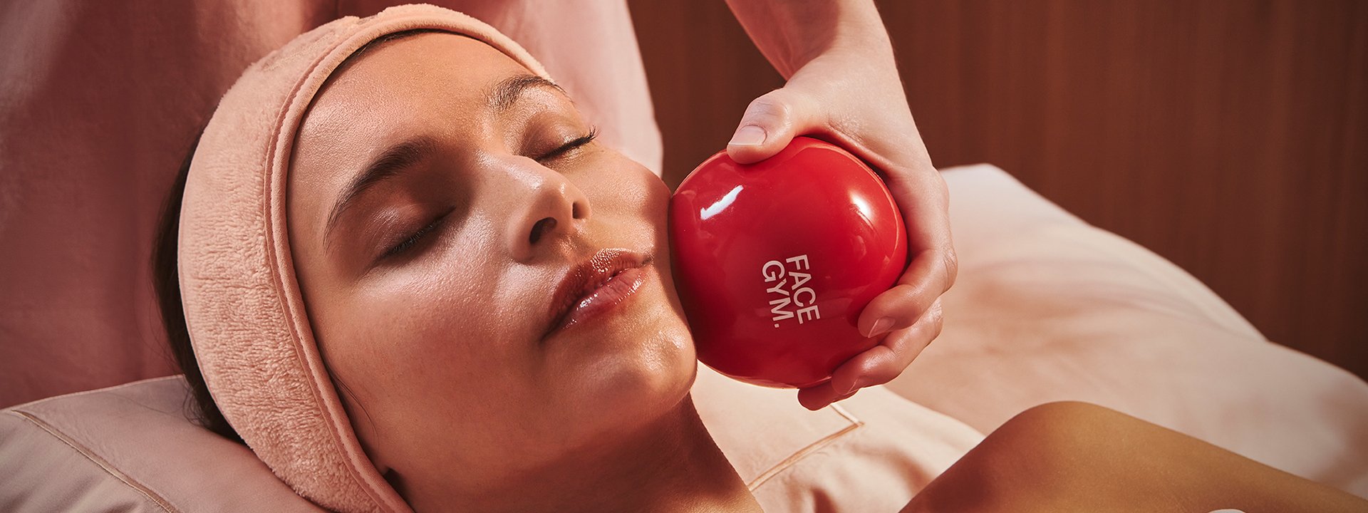 A woman at Claridge's Spa enjoying signature massage techniques with FaceGym facial treatments.