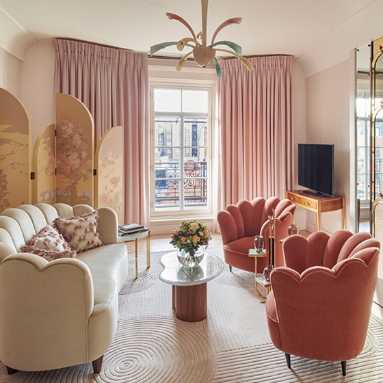 A divine interior in soft pink shades, with a sofa and armchairs in rich materials at Claridge's Hotel.