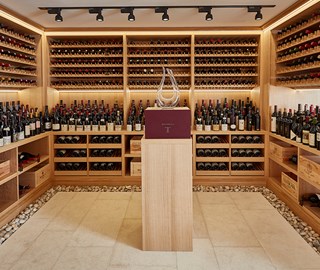 Arranged different and delicious wines on the shelves, in the premises of the wine cellar, from The Claridge's Hotel.